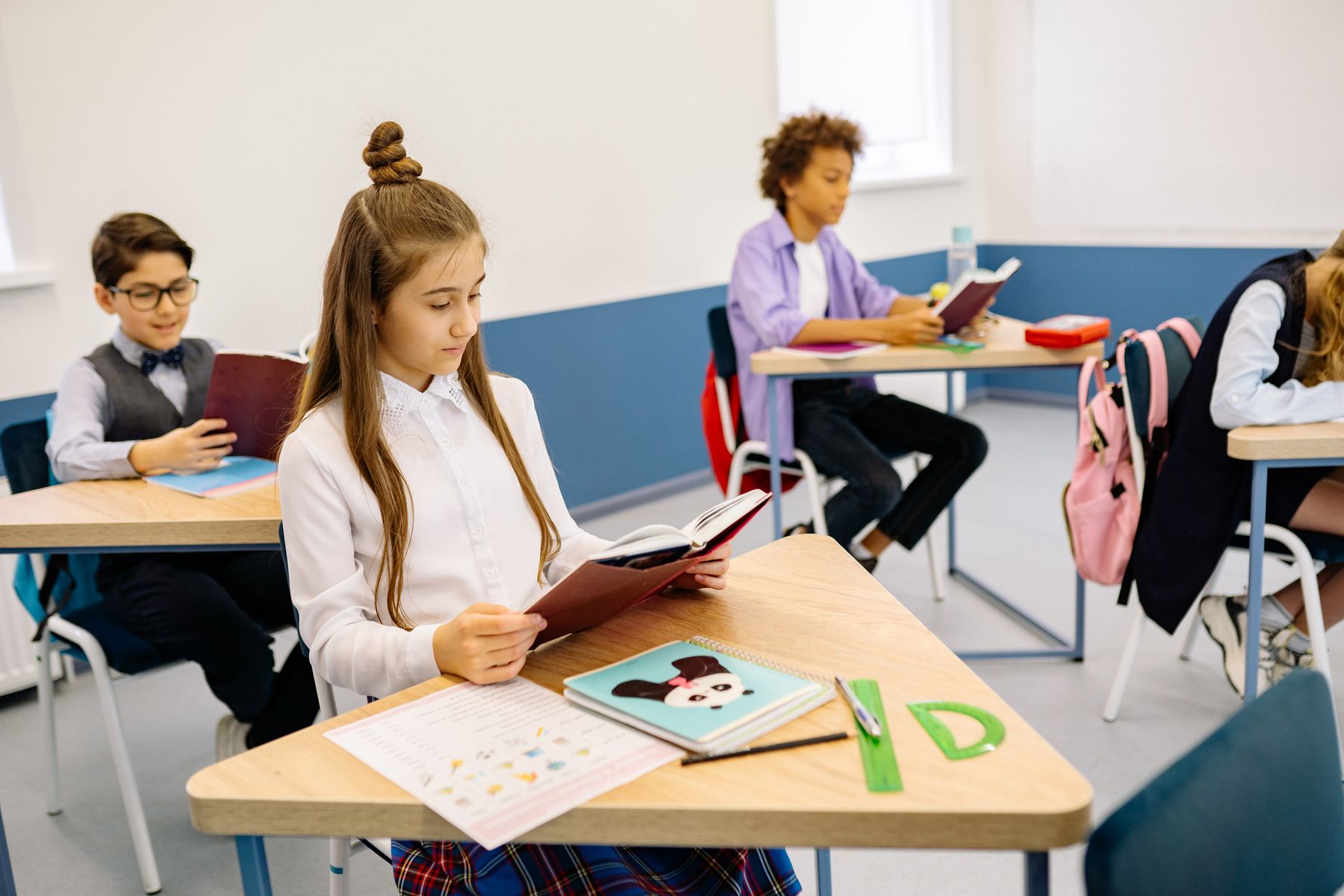 School-age children reading and working independently in a classroom