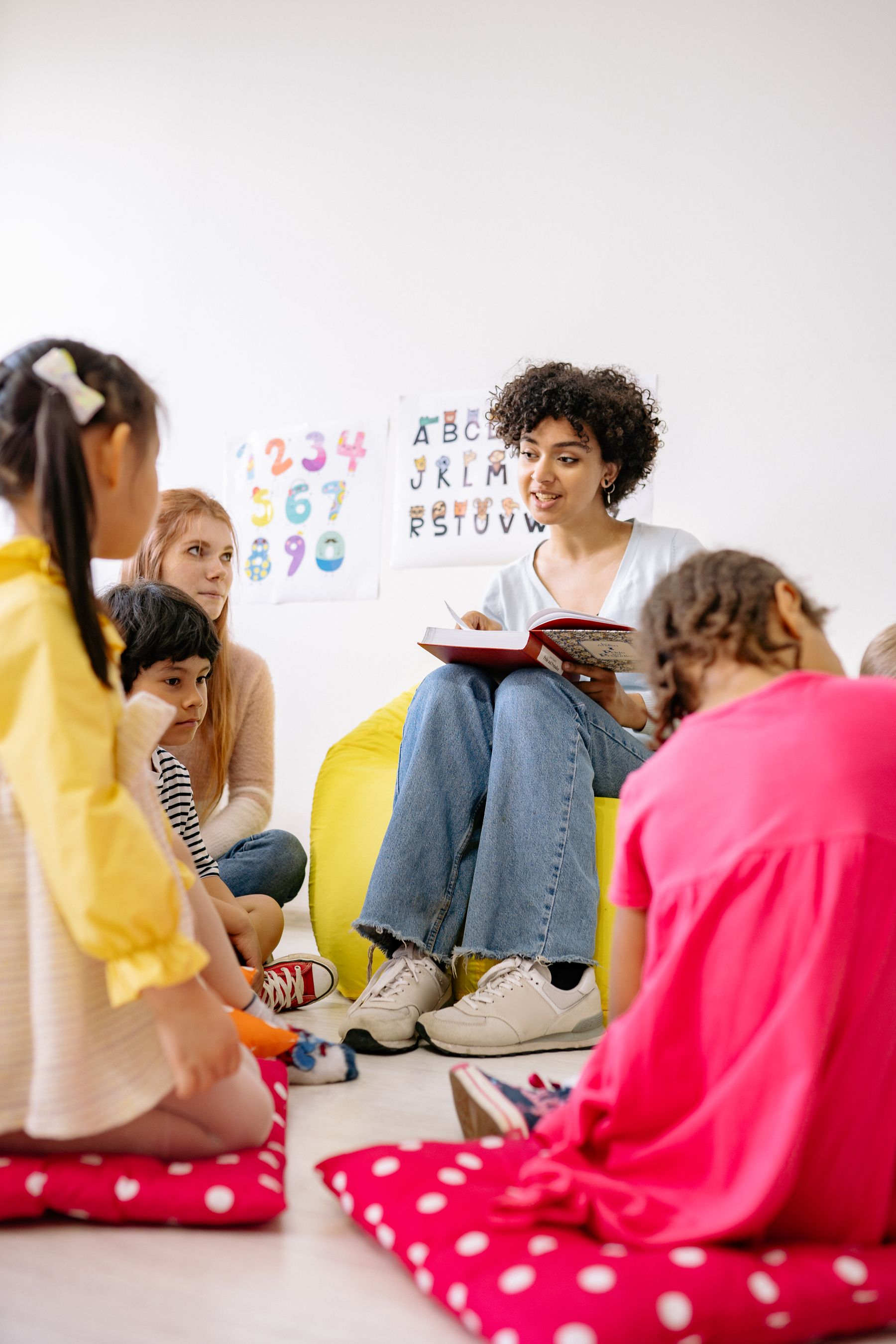 Preschool children gathered with an educator for storytime