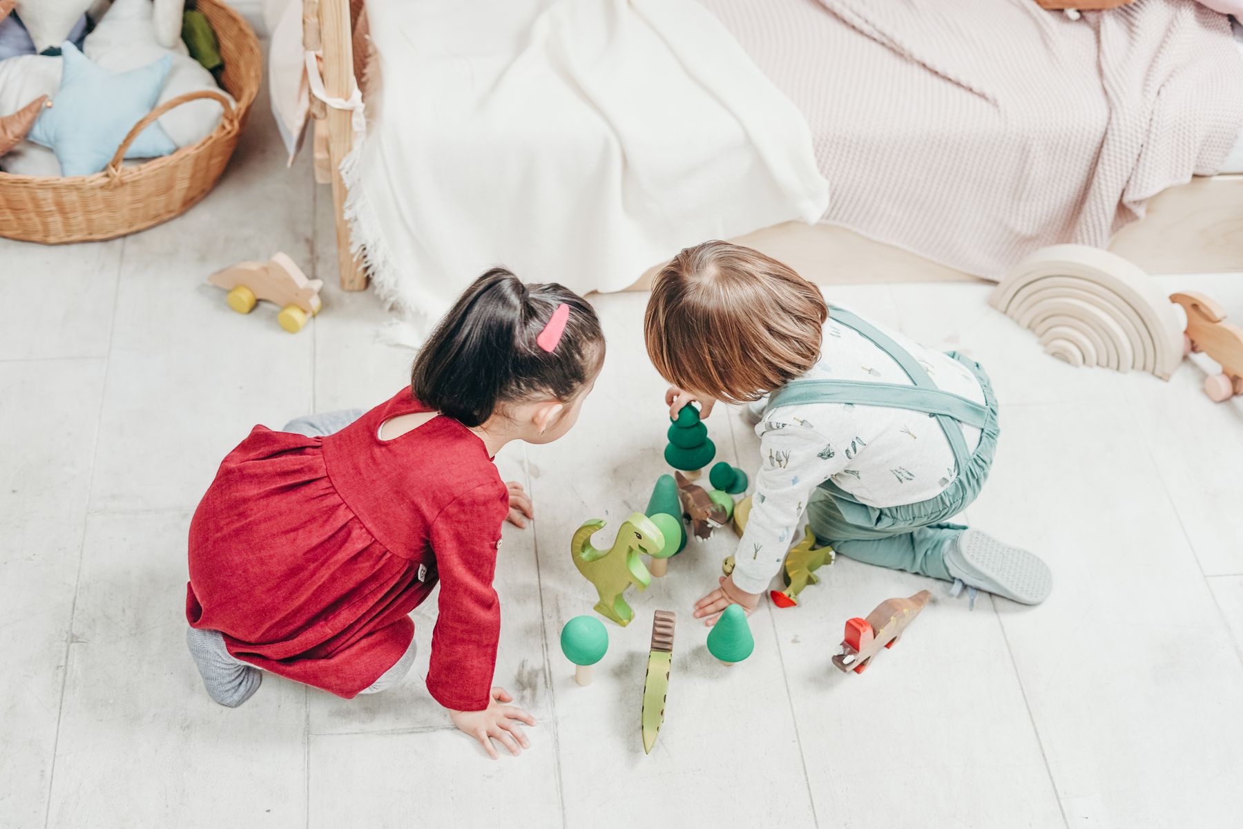 Toddlers exploring toys together through floor play