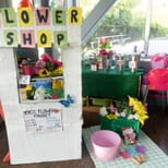 A Flower Shop dramatic-play booth with artificial flowers