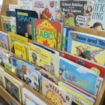 A wooden rack full of children's picture books